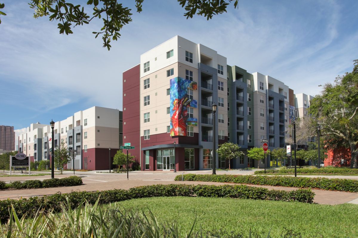 A building with many windows and trees in the background